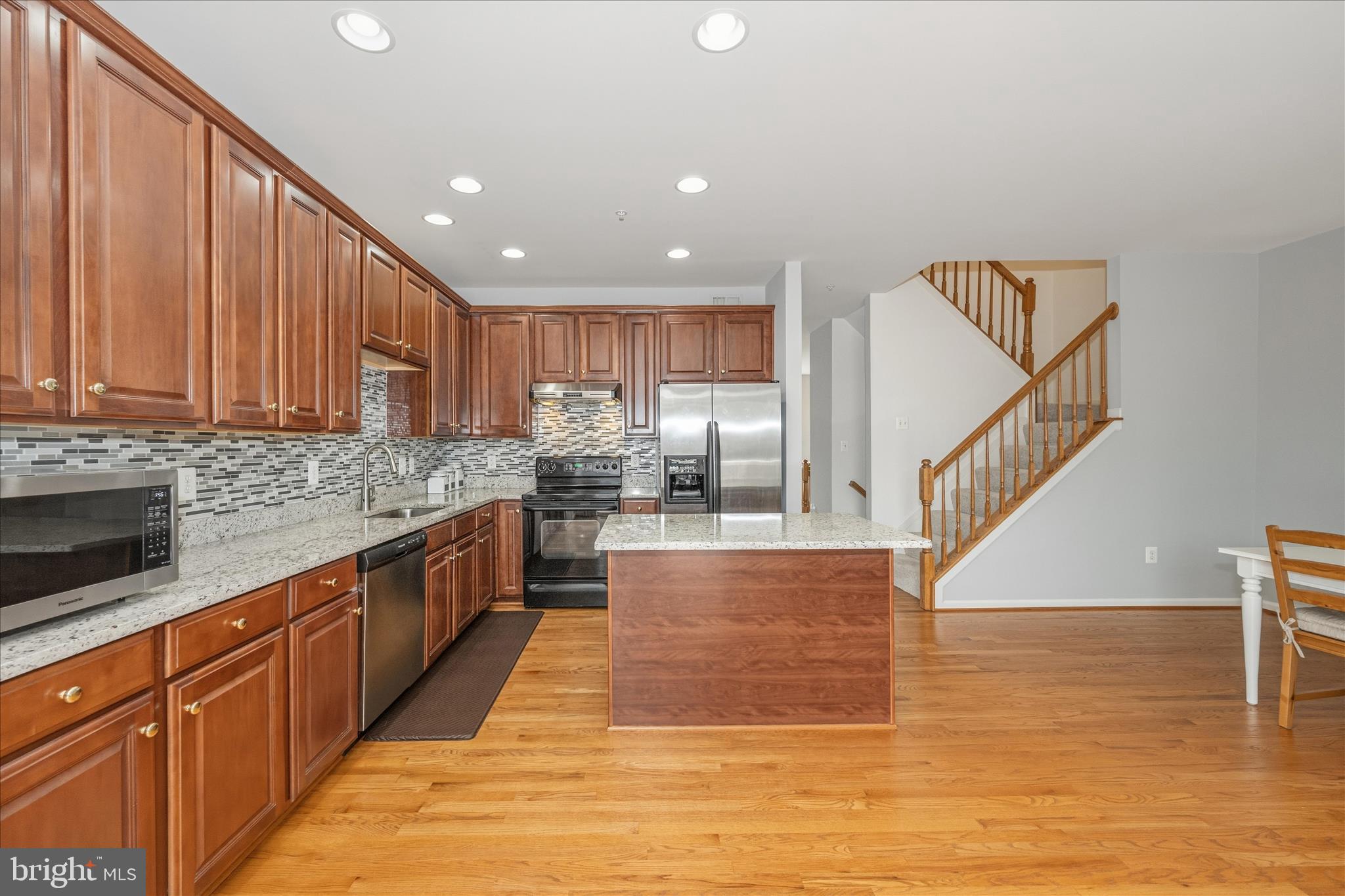 21 Inkberry Circle Gaithersburg, MD 20877 - Photo 16 of 51 a kitchen with stainless steel appliances granite countertop a sink a stove and a wooden floors