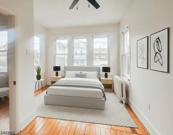 a spacious bedroom with a bed a couch and a window