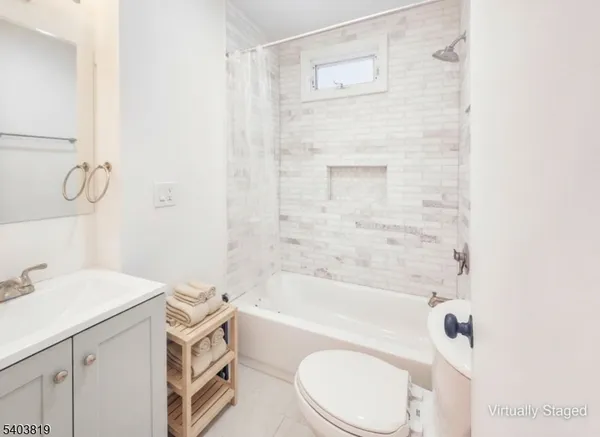 a bathroom with a sink a toilet and bathtub