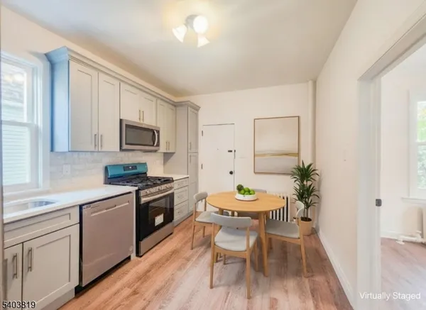 a kitchen with a sink stove and white cabinets