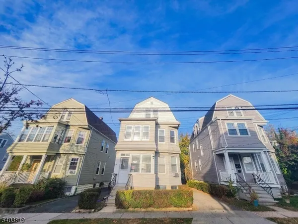 a front view of a residential apartment building with a yard