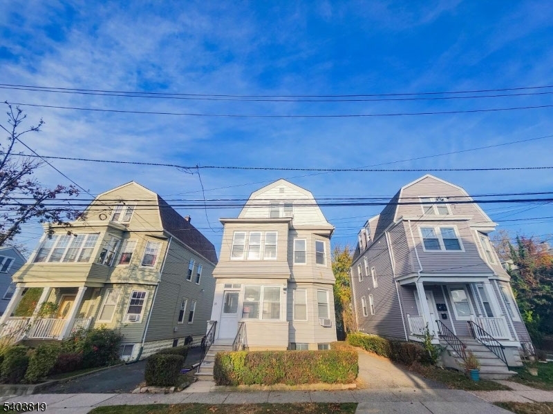 13 North Spring Street Bloomfield, NJ 07003 - Photo 6 of 12 a front view of a residential apartment building with a yard