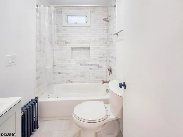 a bathroom with a toilet and a bathtub