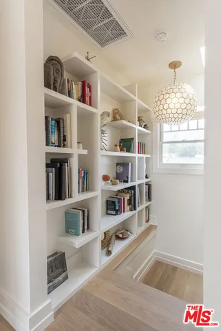 a living room with furniture and a book shelf