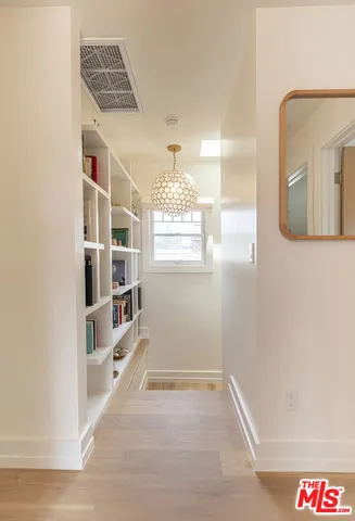 a view of a hallway with windows