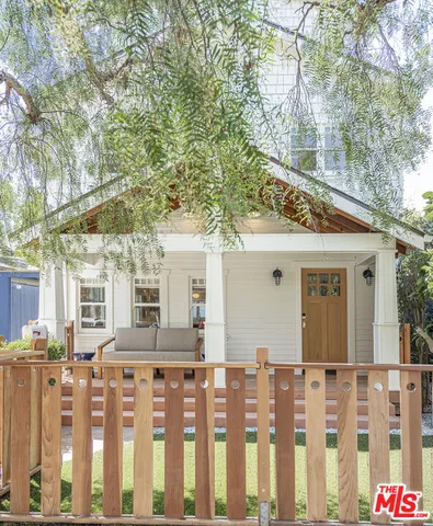 a front view of a house with wooden fence