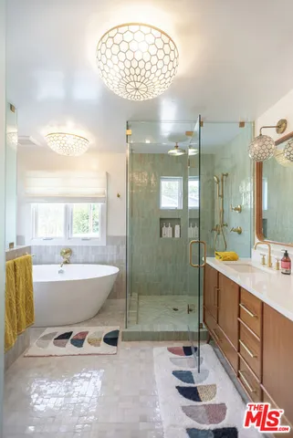 a spacious bathroom with a mirror a bathtub and shower