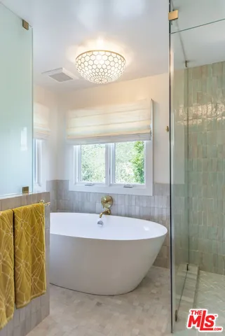 a bath tub sitting in a bathroom next to a window