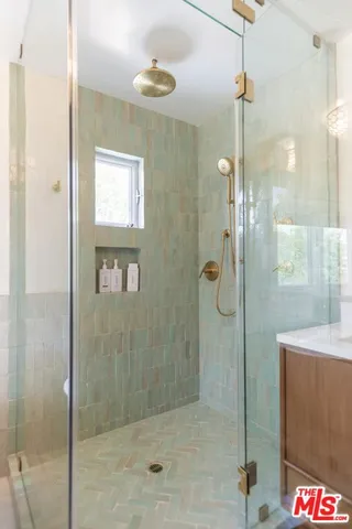 a bathroom with a shower and a sink