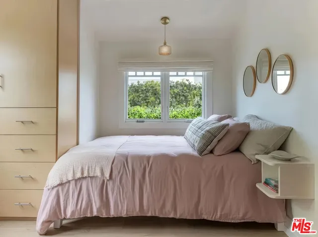 a bedroom with a bed and a window