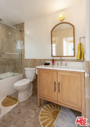 a bathroom with a toilet a sink and a mirror