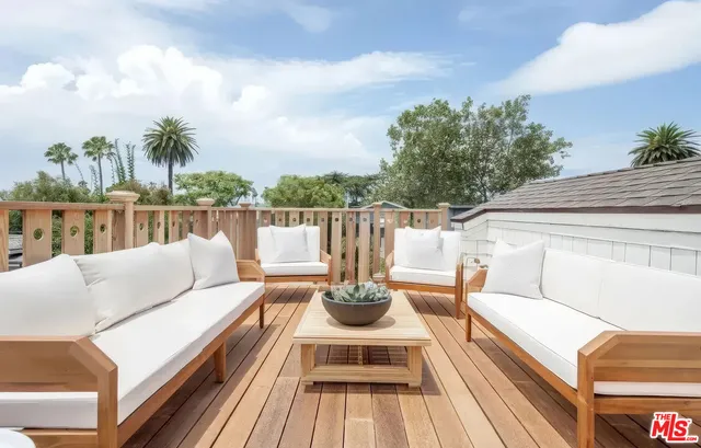 a view of balcony with couches and wooden floor
