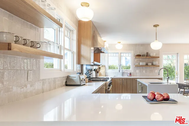 a kitchen with a sink a stove and a chandelier