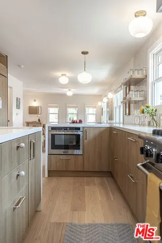 a kitchen with stainless steel appliances a stove a sink and a refrigerator