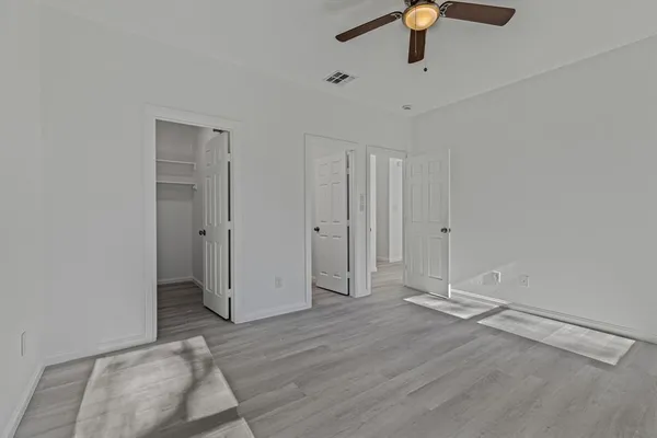 a view of empty room with wooden floor