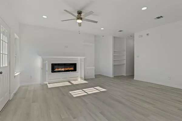 a view of a livingroom with a kitchen counter tops and wooden floor