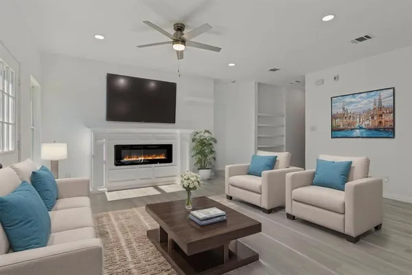 an empty room with wooden floor a fireplace and window