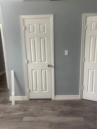 an entryway with wooden floor