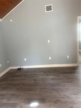 a view of a room with wooden floor