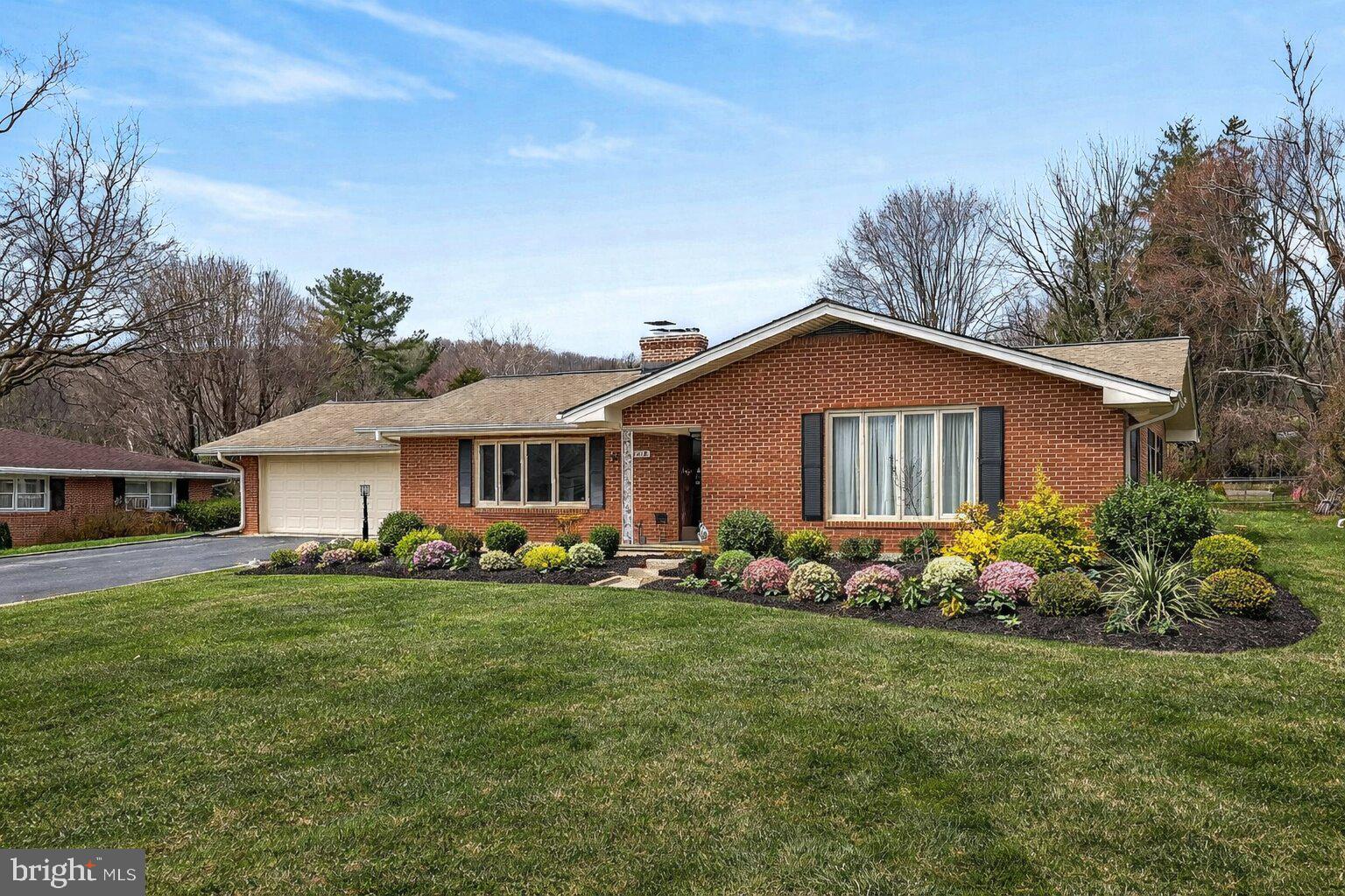 7416 Downhill Run Frederick, MD 21702 - Photo 14 of 74 a front view of a house with a garden
