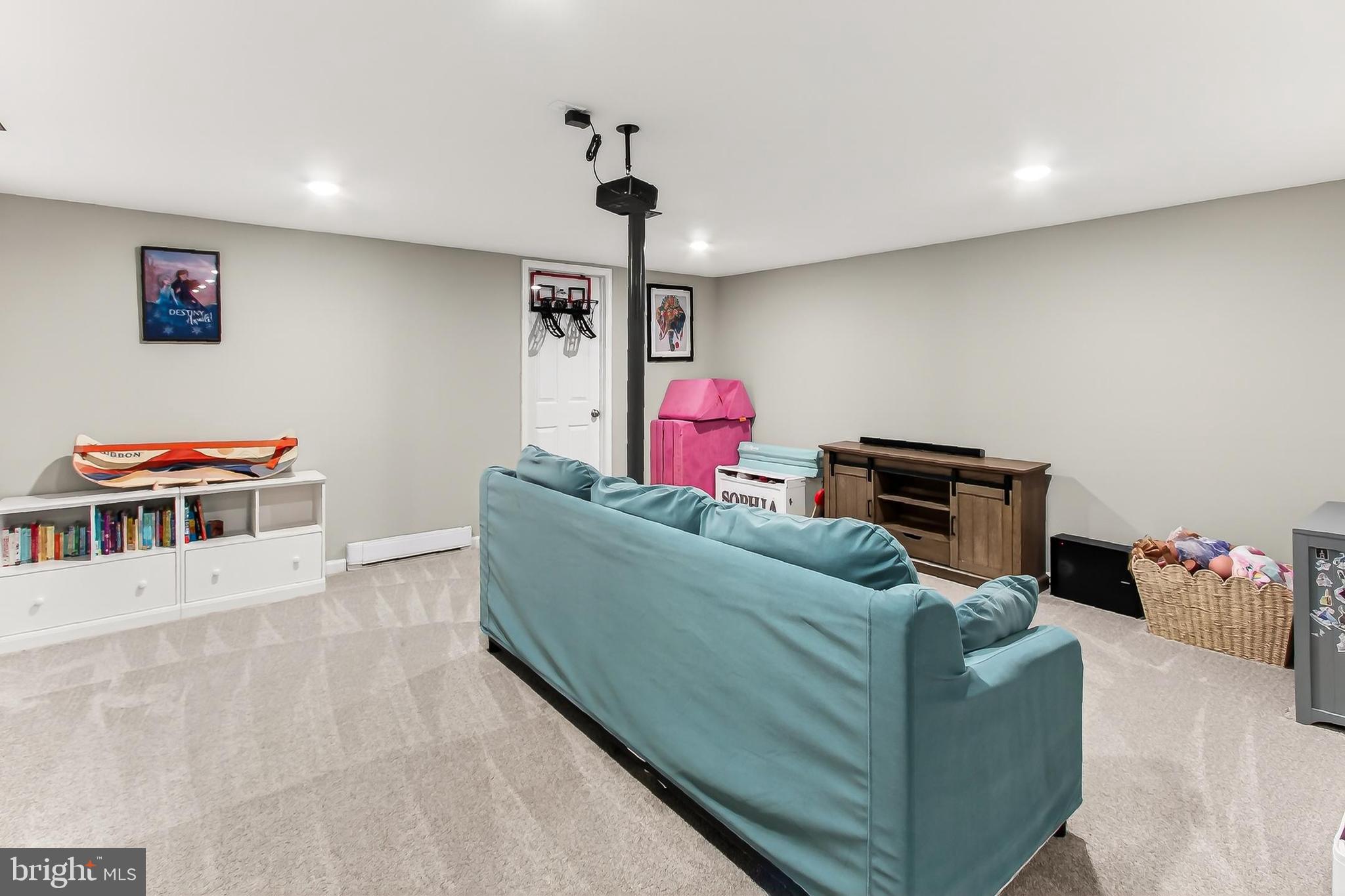 7416 Downhill Run Frederick, MD 21702 - Photo 55 of 74 a living room with furniture gym equipment and a flat screen tv