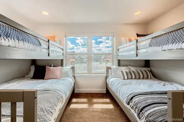 a bedroom with a large bed and a window