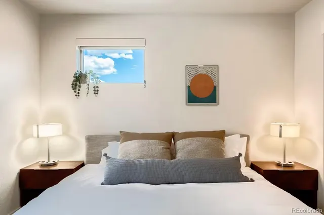 a bedroom with a bed and a lamp