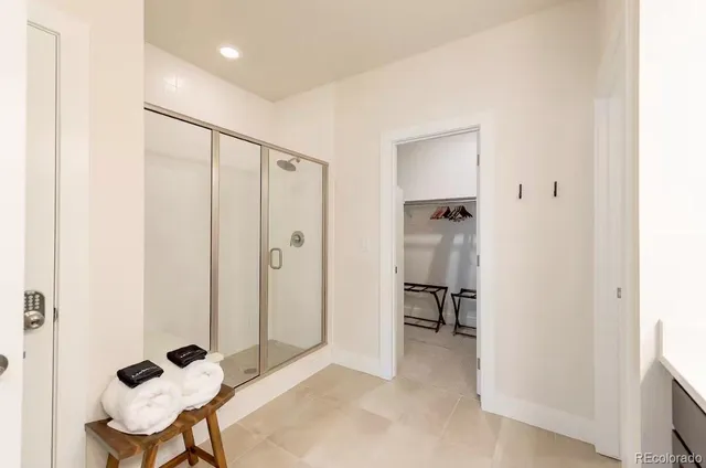a bathroom with a double vanity sink a mirror and a shower