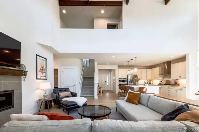 a living room with furniture kitchen view and a fireplace