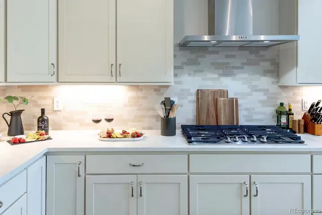 a kitchen with white cabinets and a sink