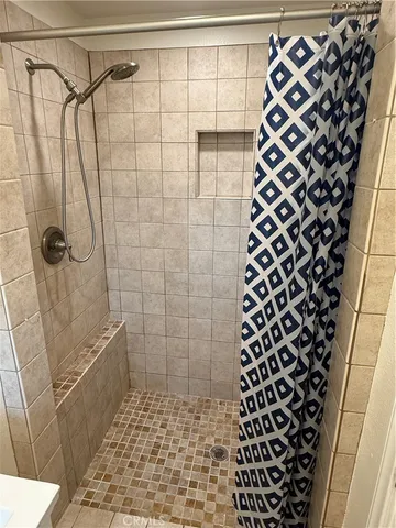 a bathroom with a shower and a toilet