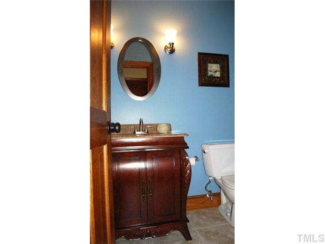 12325 Whartons Way Raleigh, NC 27613 - Photo 15 of 25 Behind closed door, updated powder room offers sophistication and grace. Half Bath