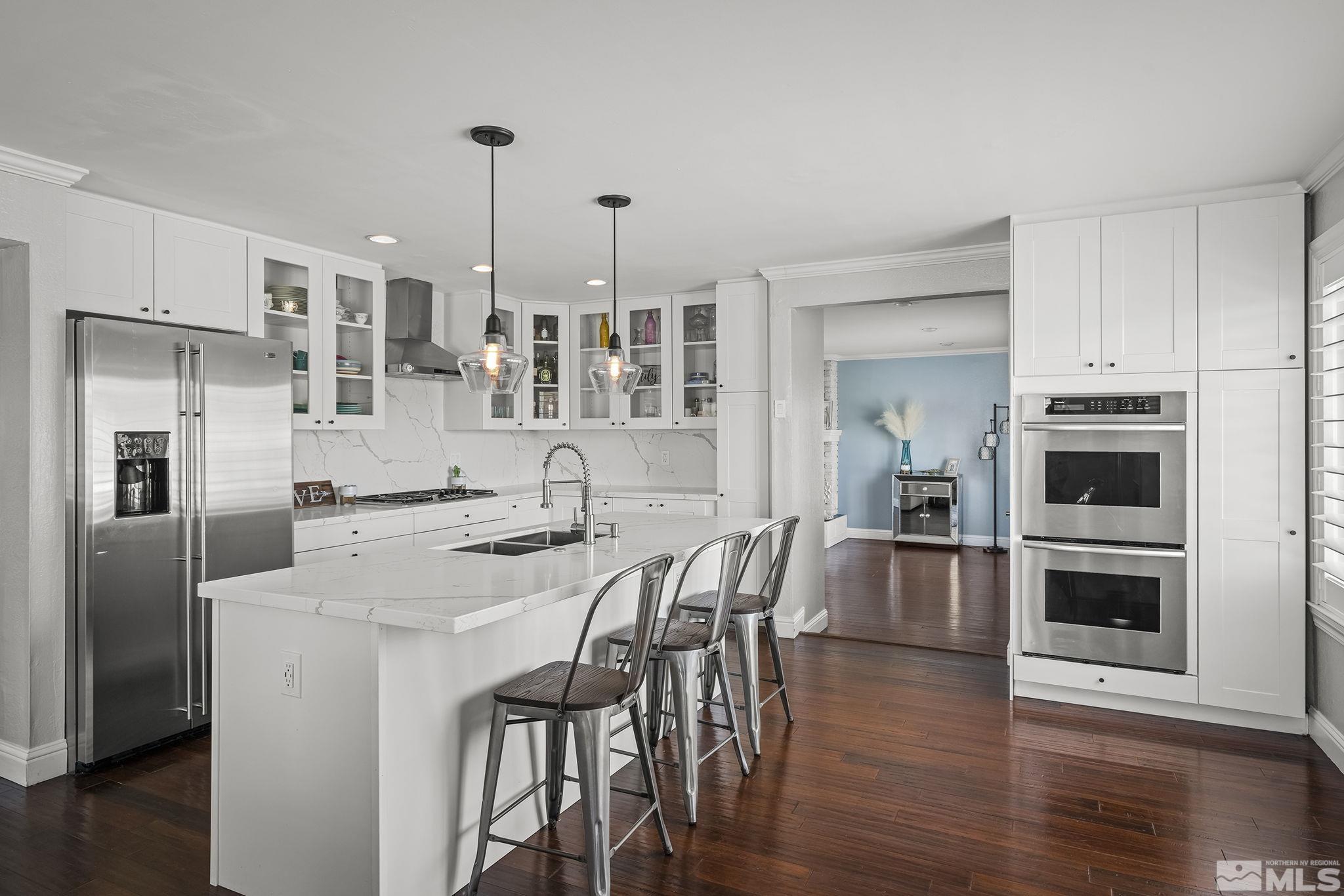 1102 Ferris Lane Reno, NV 89509 - Photo 8 of 19 a kitchen with stainless steel appliances a dining table chairs refrigerator and sink