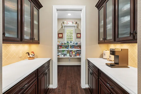 a kitchen with kitchen island a sink appliances and cabinets