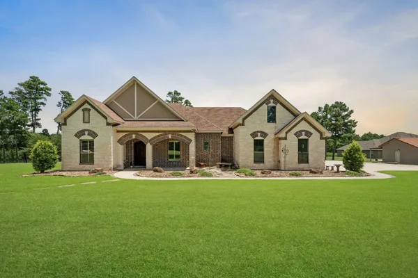 a front view of a house with a yard and garage