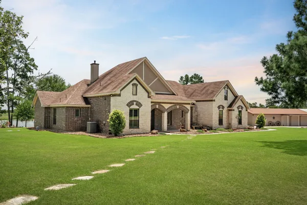 a front view of house with yard and green space