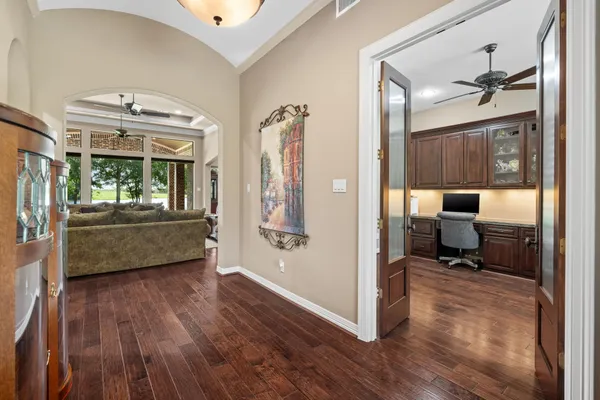 a living room with furniture and a wooden floor