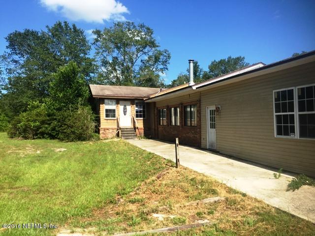 4155 Pinto Road Middleburg, FL 32068 - Photo 1 of 38 a front view of a house with a yard and garage