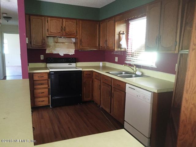 4155 Pinto Road Middleburg, FL 32068 - Photo 7 of 38 a kitchen with a sink stove and cabinets