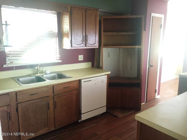 4155 Pinto Road Middleburg, FL 32068 - Photo 8 of 38 a utility room with wooden floor washer and dryer