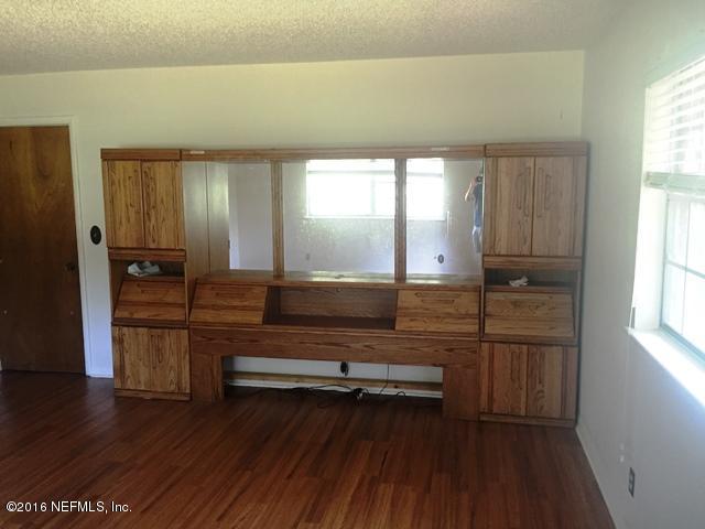 4155 Pinto Road Middleburg, FL 32068 - Photo 10 of 38 a view of a room with wooden floor and cabinet