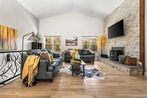 a living room with furniture floor and a flat screen tv