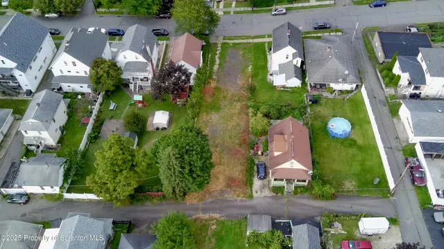 an aerial view of houses with yard