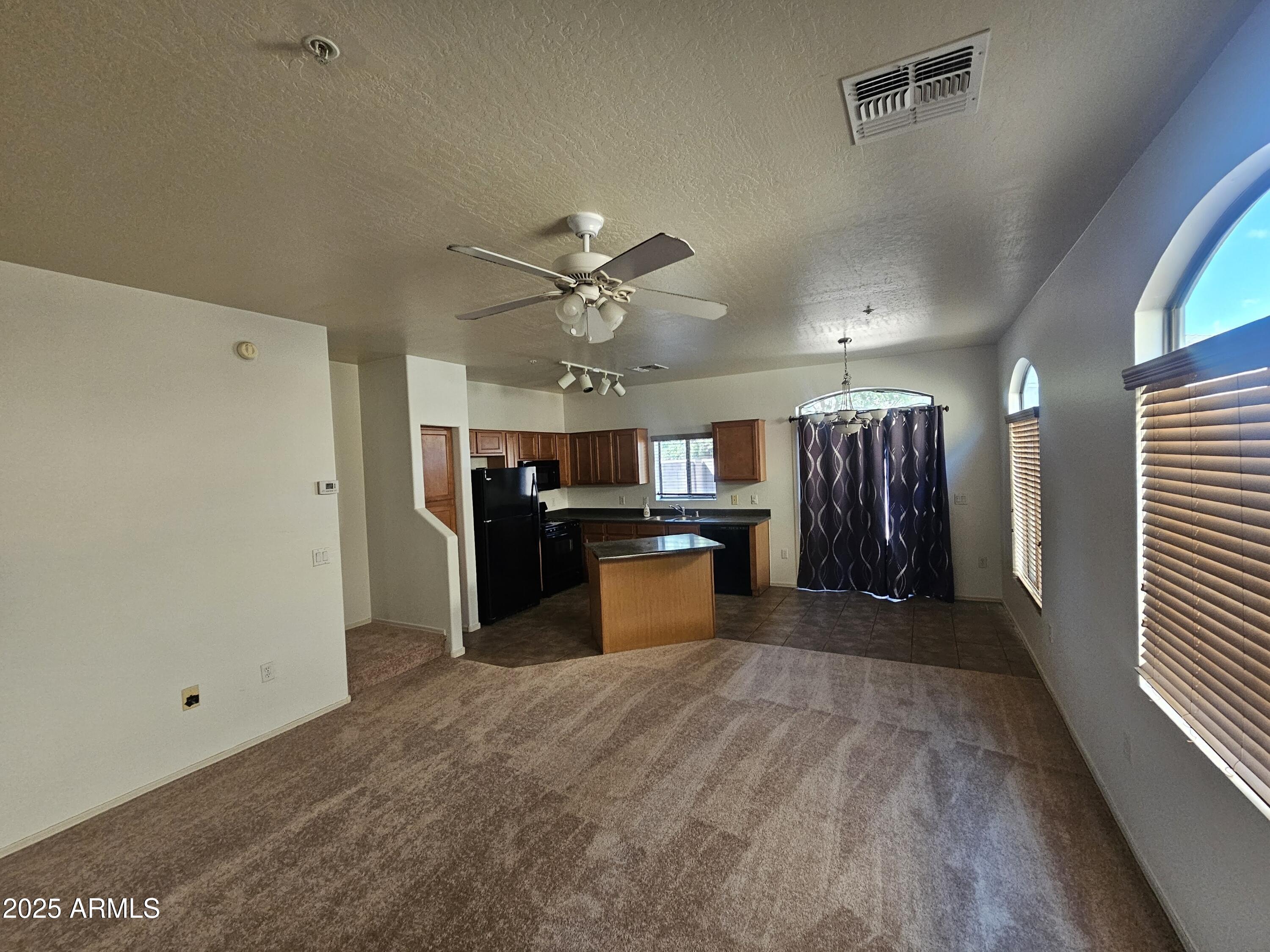 2024 South Baldwin, Unit 52 Mesa, AZ 85209 - Photo 4 of 8 a large kitchen with cabinets and stainless steel appliances