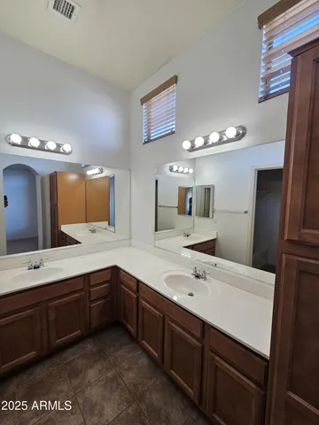 a bathroom with a sink double vanity and a mirror