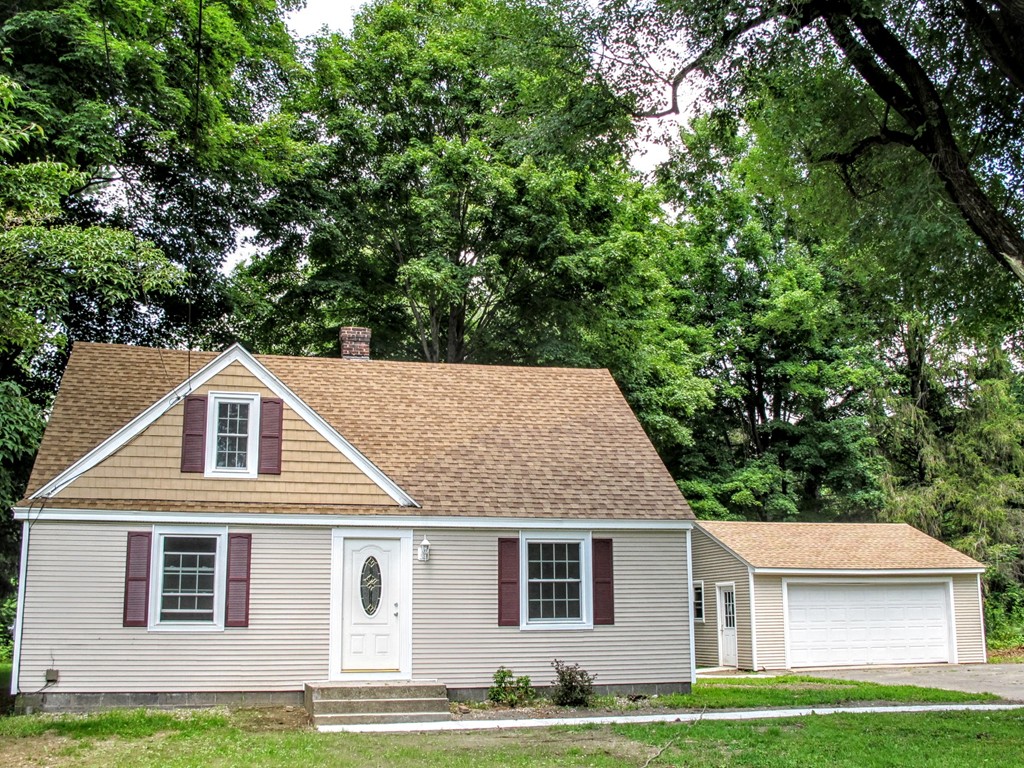 56 Plumtree Road Sunderland, MA 01375 - Photo 1 of 29 a front view of a house with a garden and yard