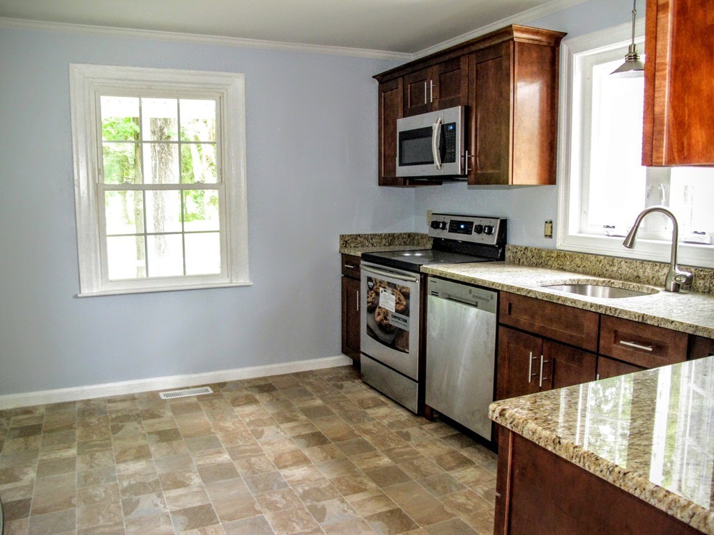 56 Plumtree Road Sunderland, MA 01375 - Photo 9 of 29 a kitchen with stainless steel appliances granite countertop a stove sink and microwave