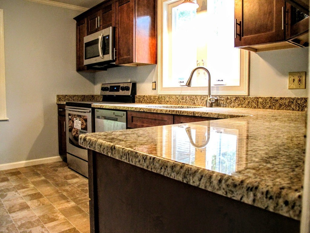 56 Plumtree Road Sunderland, MA 01375 - Photo 10 of 29 a kitchen with granite countertop a stove a sink and a microwave