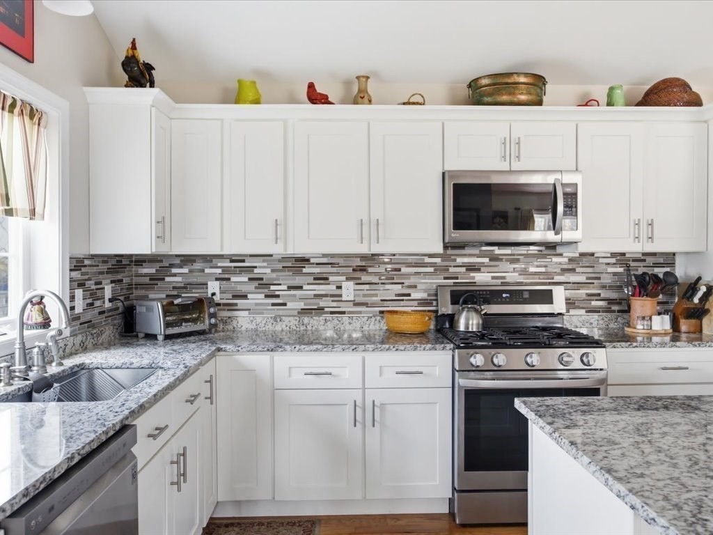 67 Ling Street Fall River, MA 02720 - Photo 13 of 32 a kitchen with granite countertop a sink a stove and microwave