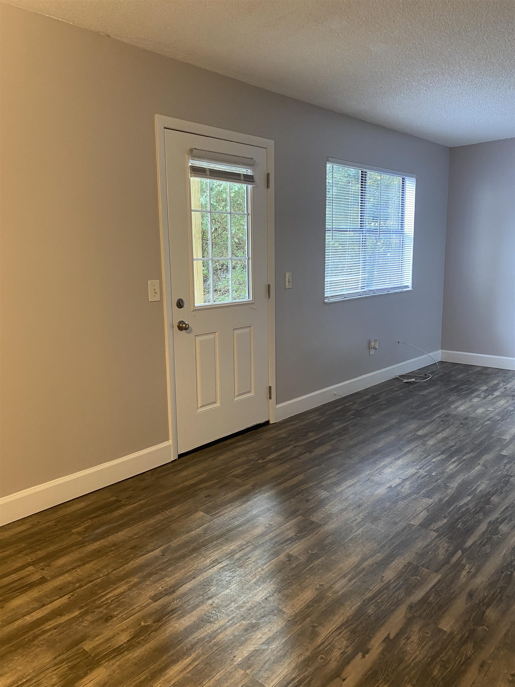 35 Atlantic Oaks Circle, Unit A St. Augustine Beach, FL 32080 - Photo 15 of 21 a view of an empty room with wooden floor and a window